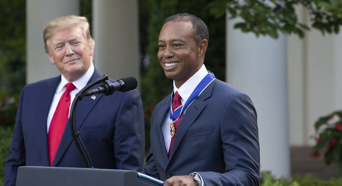 President Donald J. Trump listens as Tiger Woods addresses his remarks Monday, May 6, 2019, in the Rose Garden of the White House after being presented with the Presidential Medal of Freedom. (Official White House Photo by Joyce N. Boghosian)/ Flickr